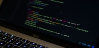 Maximize Sales: Why Python is a Game-Changer for E-commerce Website Development MacBook Pro with images of computer language codes