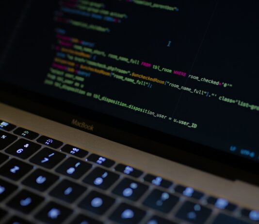 Maximize Sales: Why Python is a Game-Changer for E-commerce Website Development MacBook Pro with images of computer language codes
