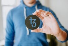 Understanding the Intersection of Crypto Regulation and Online Gambling a person holding up a black paper with the number thirteen on it