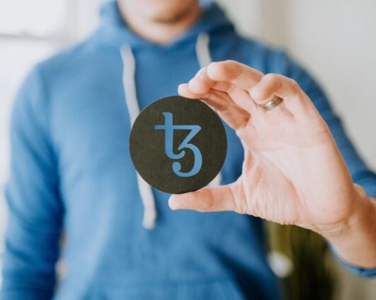Understanding the Intersection of Crypto Regulation and Online Gambling a person holding up a black paper with the number thirteen on it