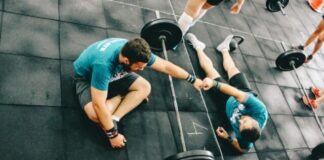 3 Things to Know About the Average Personal Trainer Cost man fist bump to man laying on ground