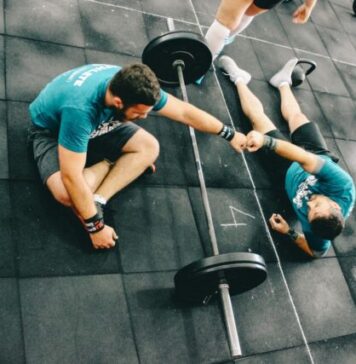 3 Things to Know About the Average Personal Trainer Cost man fist bump to man laying on ground