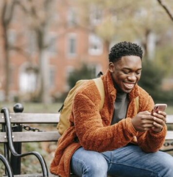 Demystifying Betting Terms: From Ante to Zig-Zag Delightful African American man surfing modern cellphone in city park