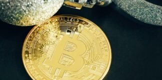 Unveiling the Perks of Bitcoin Casino Games a gold bit coin sitting on top of a black table