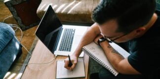 Top 5 Content Writing Industries man in black t-shirt writing on white paper