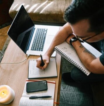 Top 5 Content Writing Industries man in black t-shirt writing on white paper