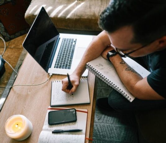 Top 5 Content Writing Industries man in black t-shirt writing on white paper