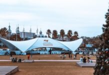 The Versatility of Mega Tents: Adaptable Structures for Various Events people sitting on bench under blue and white canopy tent during daytime