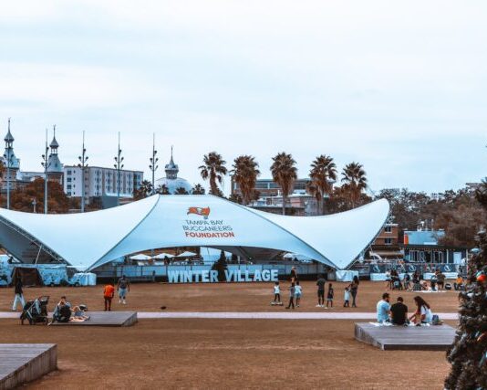 The Versatility of Mega Tents: Adaptable Structures for Various Events people sitting on bench under blue and white canopy tent during daytime