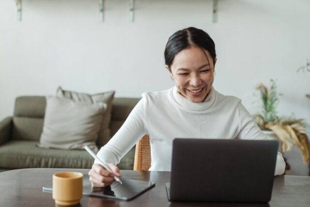 Photo by Ketut Subiyanto Woman working at home and making video call on laptop