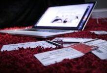 5 Ways Social Media Can Make You Go into Debt white printer paper on red textile