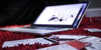 5 Ways Social Media Can Make You Go into Debt white printer paper on red textile