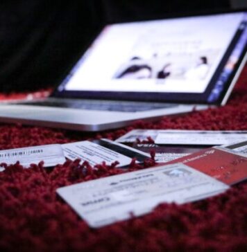 5 Ways Social Media Can Make You Go into Debt white printer paper on red textile