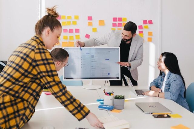 1 A team in an office discussing AI knowledge management during a meeting