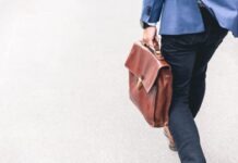 Qatar: Where to Find Jobs in Doha and Other Cities person walking holding brown leather bag