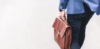 Qatar: Where to Find Jobs in Doha and Other Cities person walking holding brown leather bag