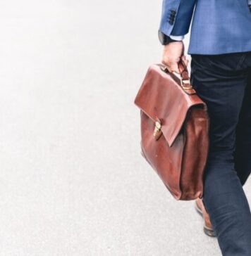Qatar: Where to Find Jobs in Doha and Other Cities person walking holding brown leather bag