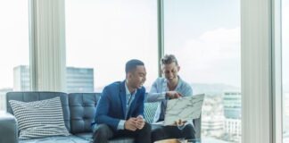 Krikya Apps Bangladesh Review two men in suit sitting on sofa