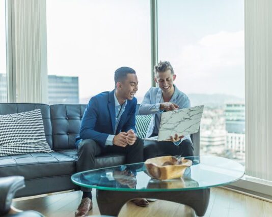 Krikya Apps Bangladesh Review two men in suit sitting on sofa