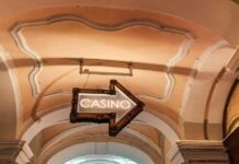 The Psychology Behind Free Spins and Bonuses a casino sign hanging from the ceiling of a building