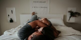 The Power of Intimacy and Sexual Health: Connecting on Physical and Emotional Levels A man and woman cuddling together in bed.