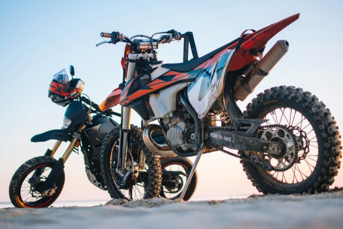 Photo by Taras Chernus selective focus photography of two white and black dual-sport motorcycles
