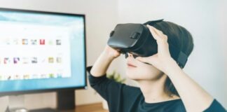 Technology Shaping the Future of Gaming woman using black VR headset beside computer