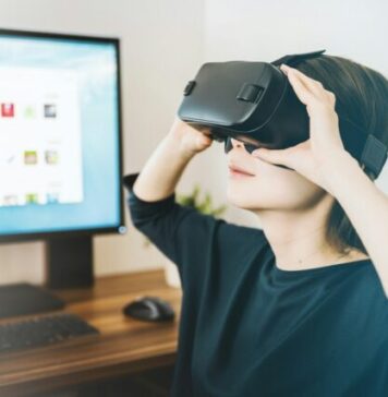 Technology Shaping the Future of Gaming woman using black VR headset beside computer