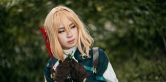 Everything New Cosplayers Need to Know woman in blue and white jacket holding black short coated dog