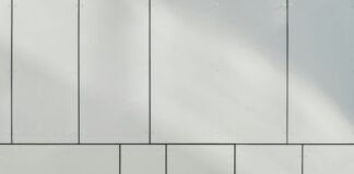 Enhancing a Building Frontage: How Panel Facades Are Breathing New Life into Business a white wall with a clock on the side of it