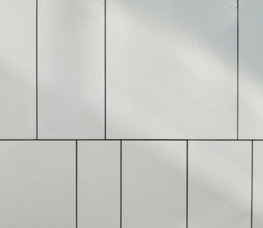 Enhancing a Building Frontage: How Panel Facades Are Breathing New Life into Business a white wall with a clock on the side of it