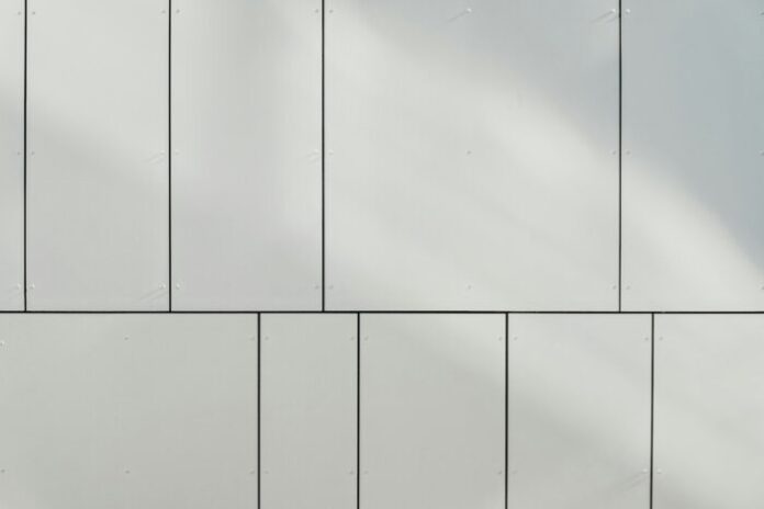 Photo by Bernard Hermant a white wall with a clock on the side of it