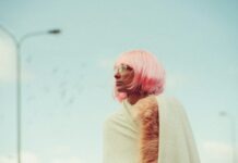 The Ultimate Guide to Caring for Your Luxury Bob Wig woman looking sideways near light post