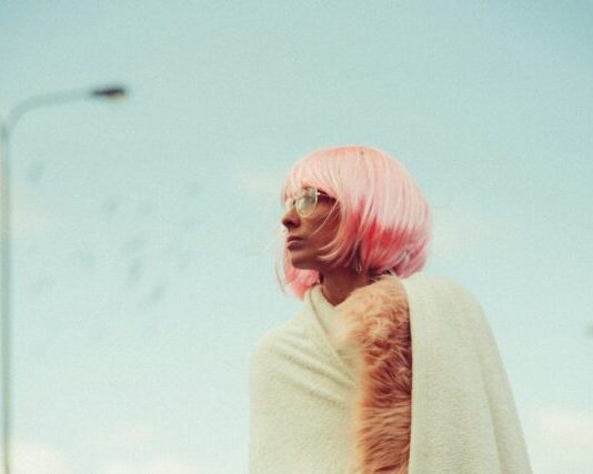 The Ultimate Guide to Caring for Your Luxury Bob Wig woman looking sideways near light post