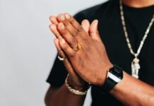 Top Trends in Sports Ring Designs for 2024 a man in a black shirt is holding his hands together