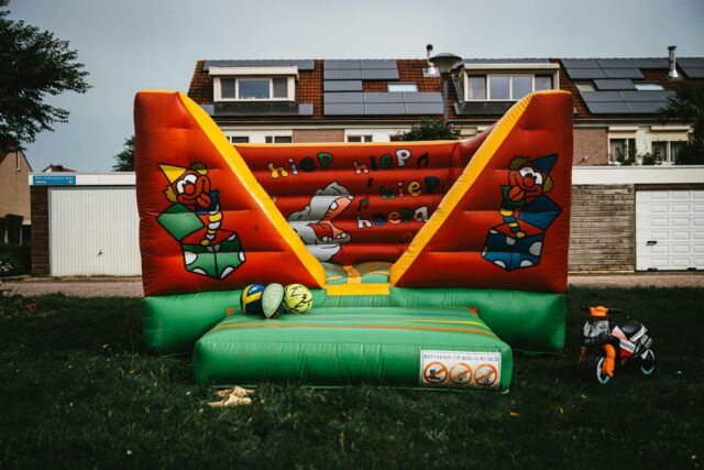 Photo by Michal Balog a large inflatable bouncer in a yard