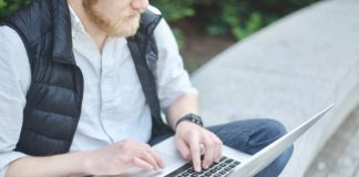 Tips and Strategies for Mastering the Aviator Game man using MacBook while sitting on bench