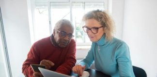 Top 5 Features to Look for in a Modern CTMS System Elderly couple using a laptop in a bright room, focusing on online activities together.