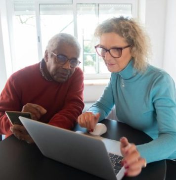 Top 5 Features to Look for in a Modern CTMS System Elderly couple using a laptop in a bright room, focusing on online activities together.