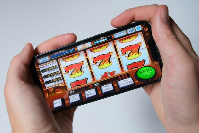 Photo by Niek Doup Someone is playing a mobile slot machine game.